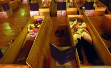 Course members get into their coffins and a flower is laid on each persons chest