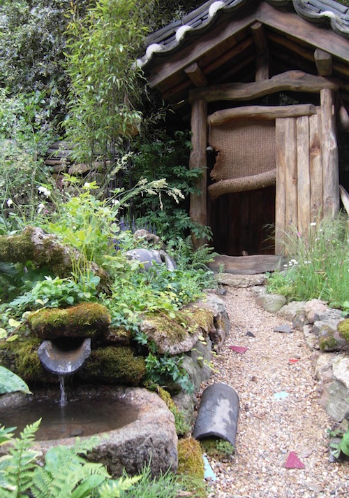 Beside the nicely unkempt path is a basin for washing hands