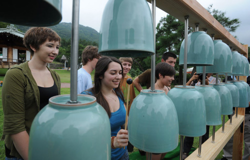 Foreign students play celadon bells at a celadon museum in Gangjin