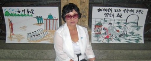 Kim Hye Sook with two of her paintings