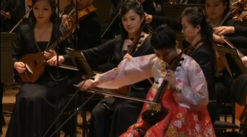 Ha Nam-un playing a four-stringed haegum. Note a similar haegum and a mandolin (oungum) in the orchestra behind
