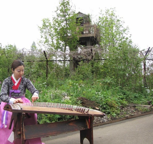 Jung Ji-eun performs on the Kayageum to celebrate the garden's opening