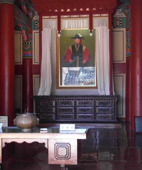 A small shrine to Yi Sun-shin in his command centre. The blue roof of the entrance gate is reflected in the glazing of the memorial portrait A small shrine to Yi Sun-shin in his command centre. The blue roof of the entrance gate is reflected in the glazing of the memorial portrait