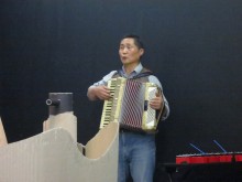 The accordionist accompanies with simple melodies throughout
