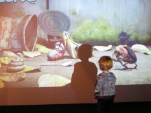 A young visitor is entertained by some of the animation