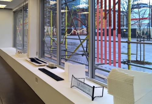 Infographics on the windows of the exhibition do battle with coloured scaffolding poles in the street outside (photo: LKL)