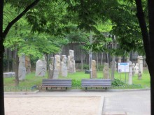 Some of the better-preserved funerary statues have been incongruously gathered together in a children's playground