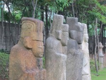 Some of the better-preserved funerary statues have been incongruously gathered together in a children's playground