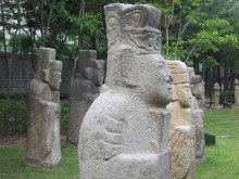 Some of the better-preserved funerary statues have been incongruously gathered together in a children's playground