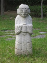 Some of the better-preserved funerary statues have been incongruously gathered together in a children's playground