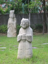 Some of the better-preserved funerary statues have been incongruously gathered together in a children's playground