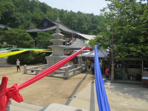Festive streamers stretch between the buildings