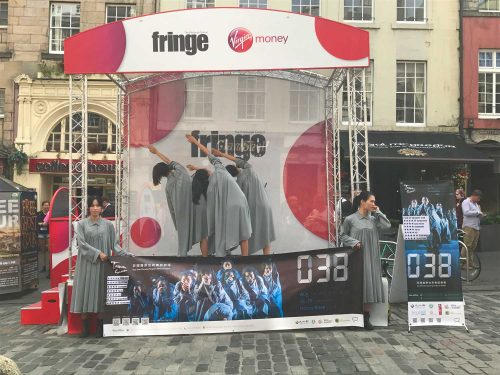 Taiwanese performers advertise their show on the Royal Mile