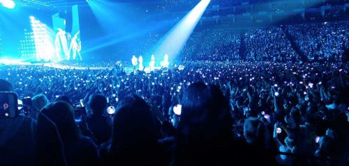 BTS and the audience bathed in the blue light of the ARMY bombs