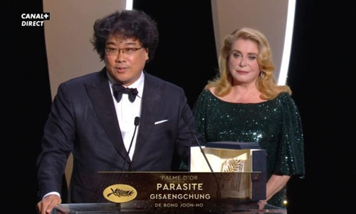 Bong Joon-ho accepts the award from Catherine Deneuve
