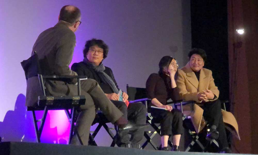 Bong Joon-ho and Song Kang-ho answering questions with the assistance of Sharon Choi