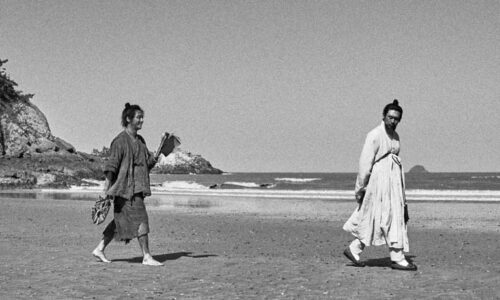 Fisherman and exiled scholar walk on the beach in Lee Joon-ik's Book of Fish