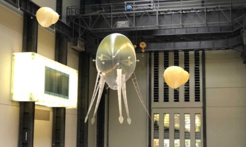 strange blimps floating in Tate Modern Turbine Hall