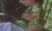 Soft-focus shot of two teenage schoolgirls in a wood
