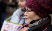 An elderly Korean lady in a woolly hat
