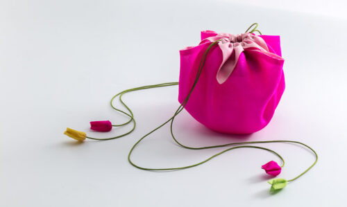 A bright pink silk pouch