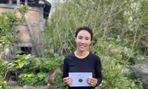 Hwang Jihae holds her Chelsea Gold Medal at the entrance to her garden