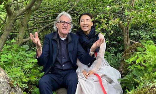 Paul Smith and Hwang Jihae sit together in the garden