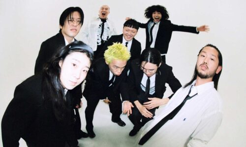 A group of young Korean rappers strike a pose