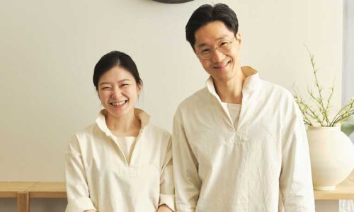 Chef Woongchul Park and Chef Bomee Ki: a smiling Korean couple in chef's whites