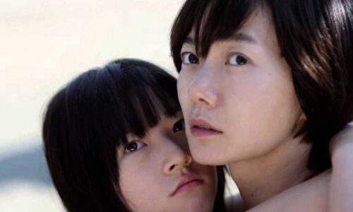 A woman embraces a distressed-looking child