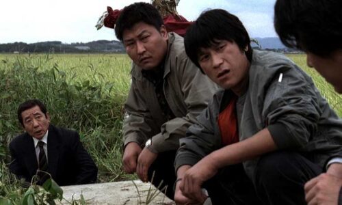 Murder detectives squat in a field