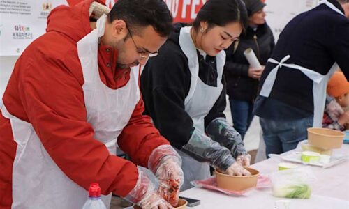 People learning to make kimchi